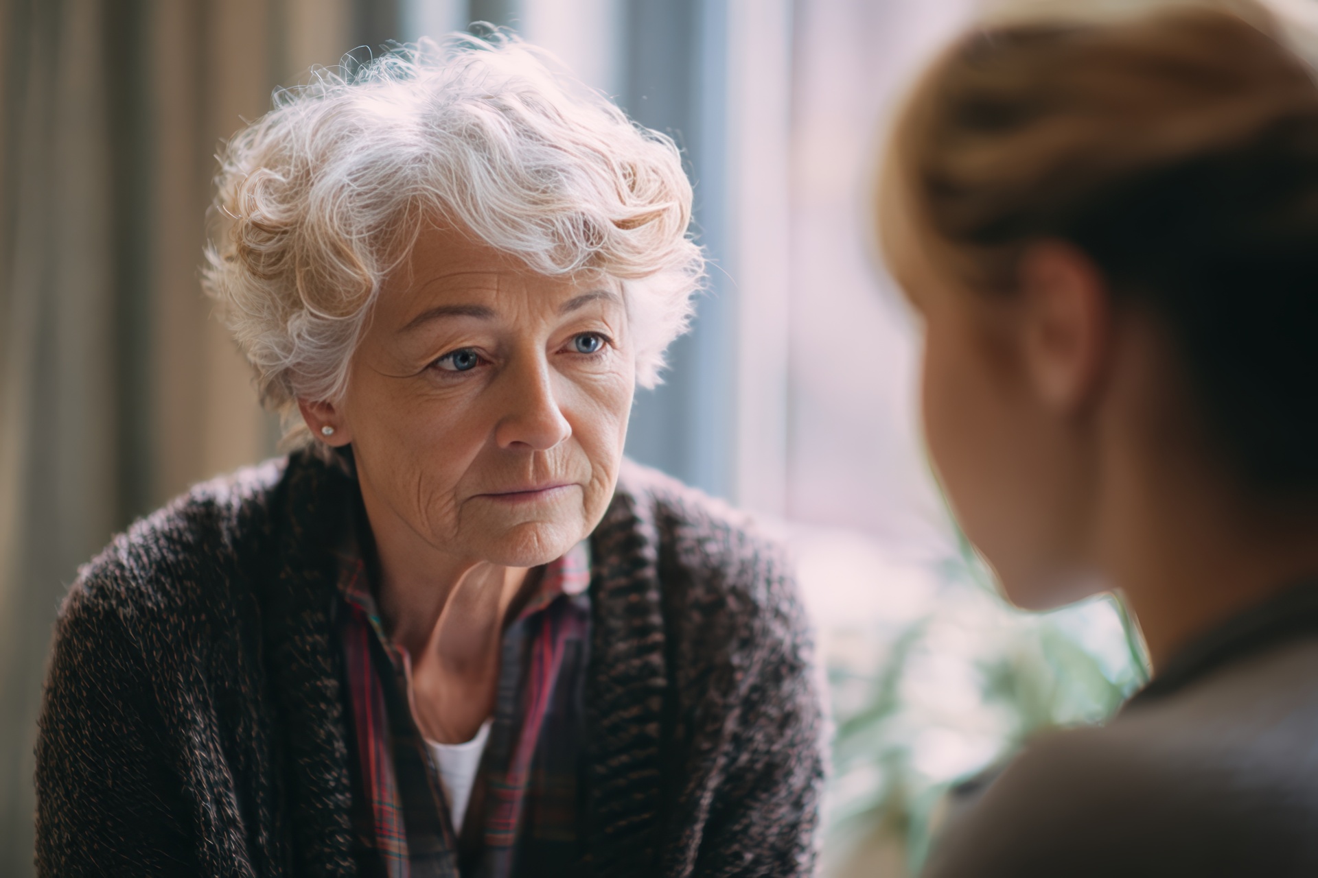 Bereavement counselor providing gentle comforting support to elderly woman in peaceful quiet environment with empathy, ideal for hospice care and bereavement support grief counseling compassion.