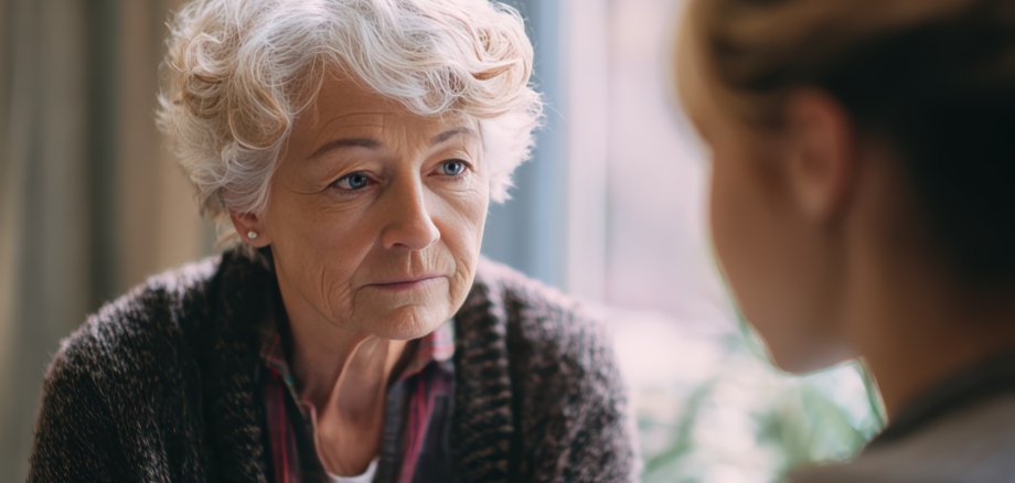Bereavement counselor providing gentle comforting support to elderly woman in peaceful quiet environment with empathy, ideal for hospice care and bereavement support grief counseling compassion.